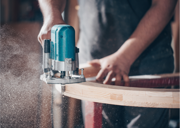 A power drill cuts through wood